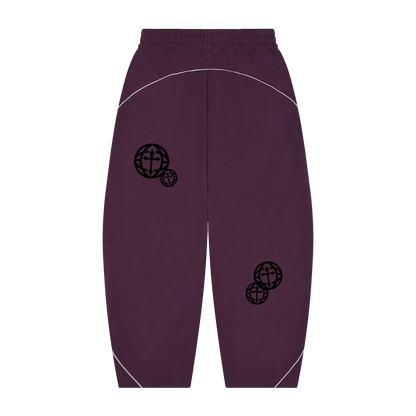 A pair of dark purple sweatpants with black globe graphics on the upper legs and white curved piping details, shown against a plain white background.