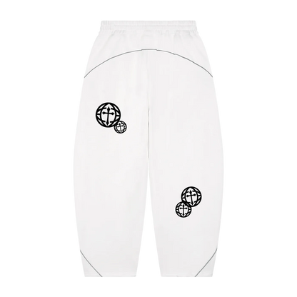 White sweatpants with black embroidered globe graphics on the left thigh and lower left leg, featuring a curved black line detail across the upper back thigh and subtle piping at the ankle cuffs.