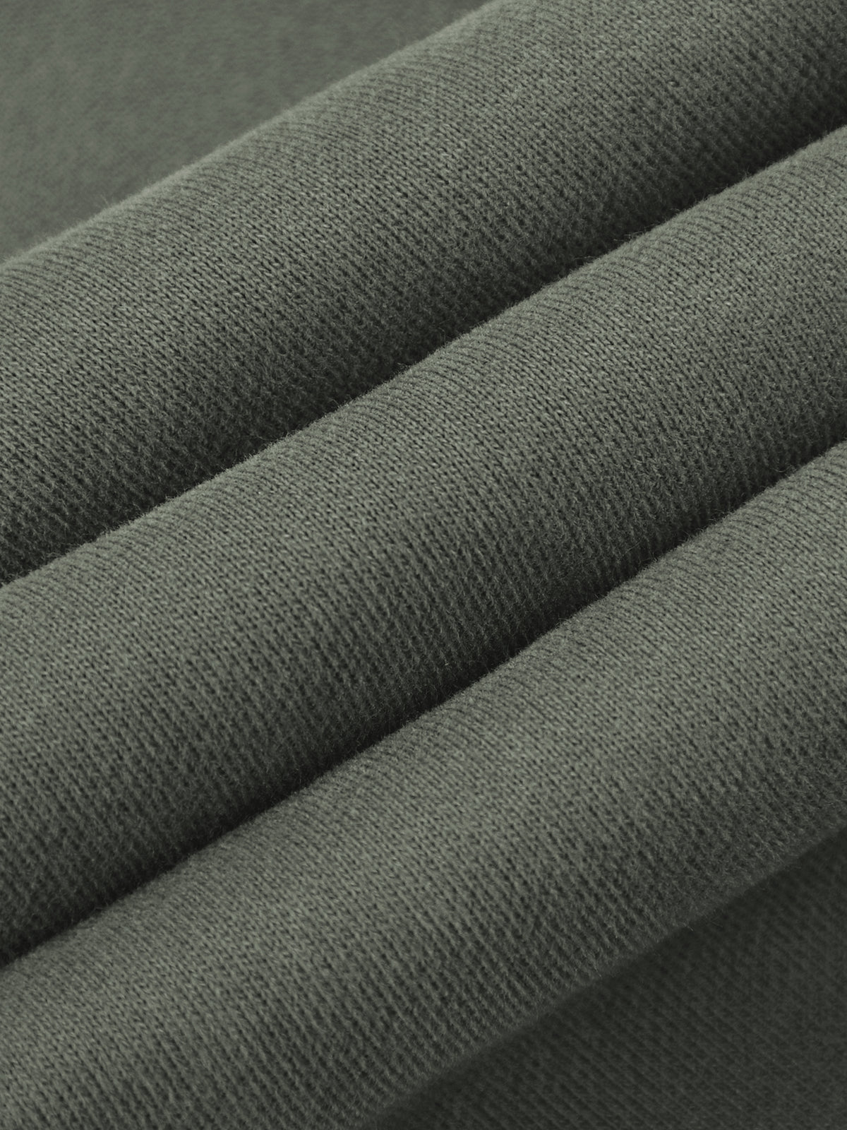 A close-up of folded dark gray fabric showing its fine woven texture.