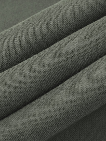A close-up of folded dark gray fabric showing its fine woven texture.