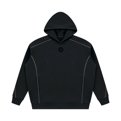 A black pullover hoodie with white contrast piping details along the shoulders and sides, featuring a small black circular logo on the center chest, displayed on a solid white background.