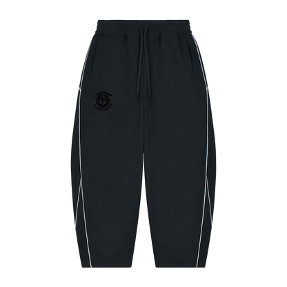 Black jogger-style pants with white side piping and a black circular chest emblem, shown flat against a white background.