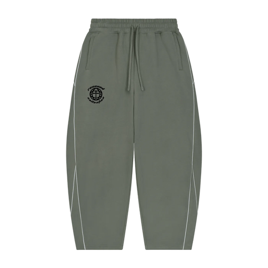 Olive green jogger-style pants with a black embroidered compass logo on the left chest, white piping along the outer sides, and a drawstring waistband, shown against a plain white background.