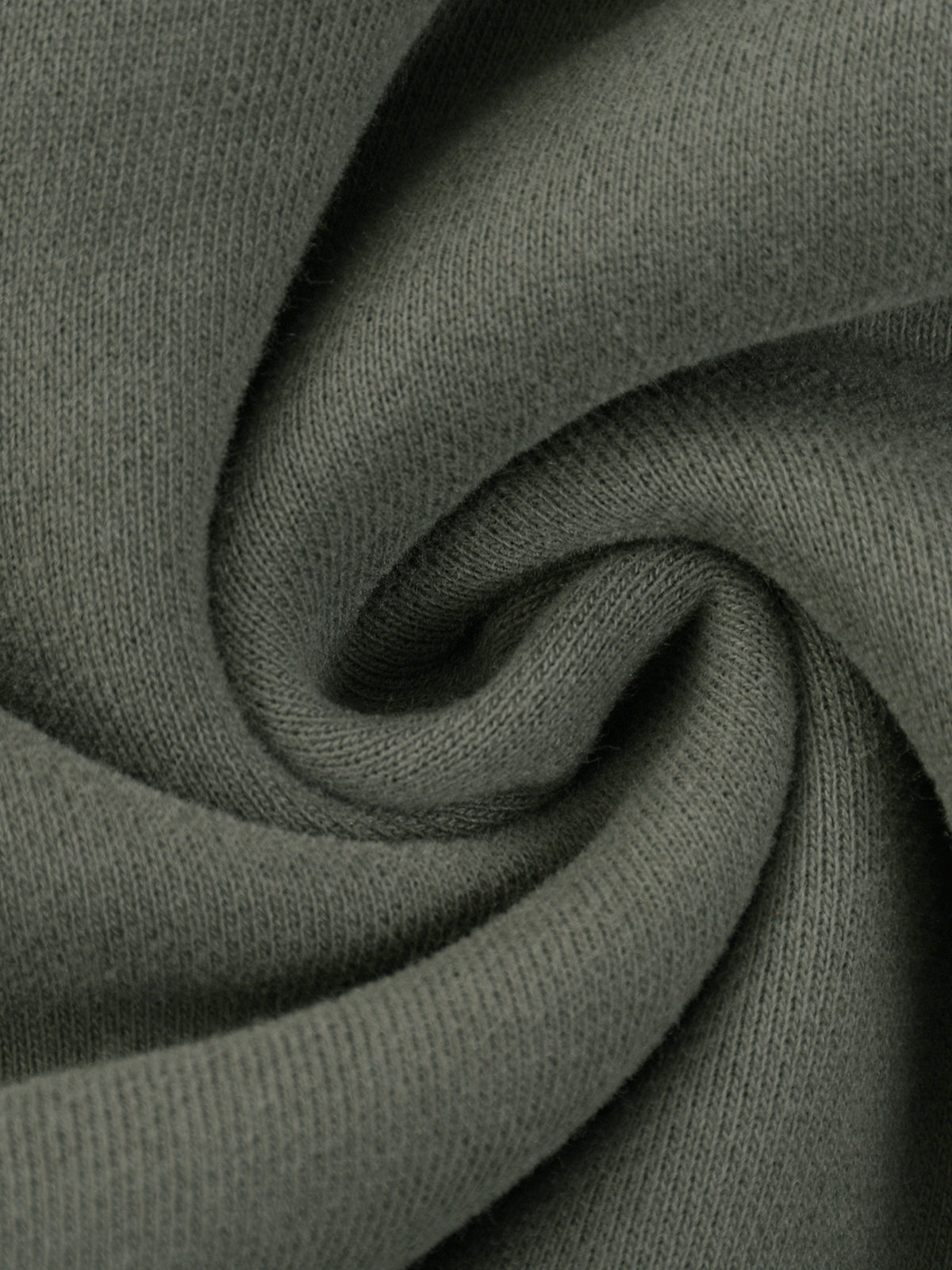 A close-up of a dark olive green knit fabric, swirled into a spiral pattern to show the texture and drape.