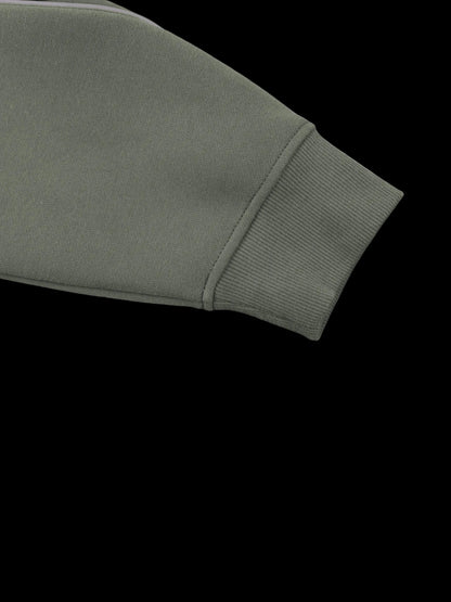 Close-up of a ribbed knit sleeve cuff in a muted olive green color, shown against a plain white background.