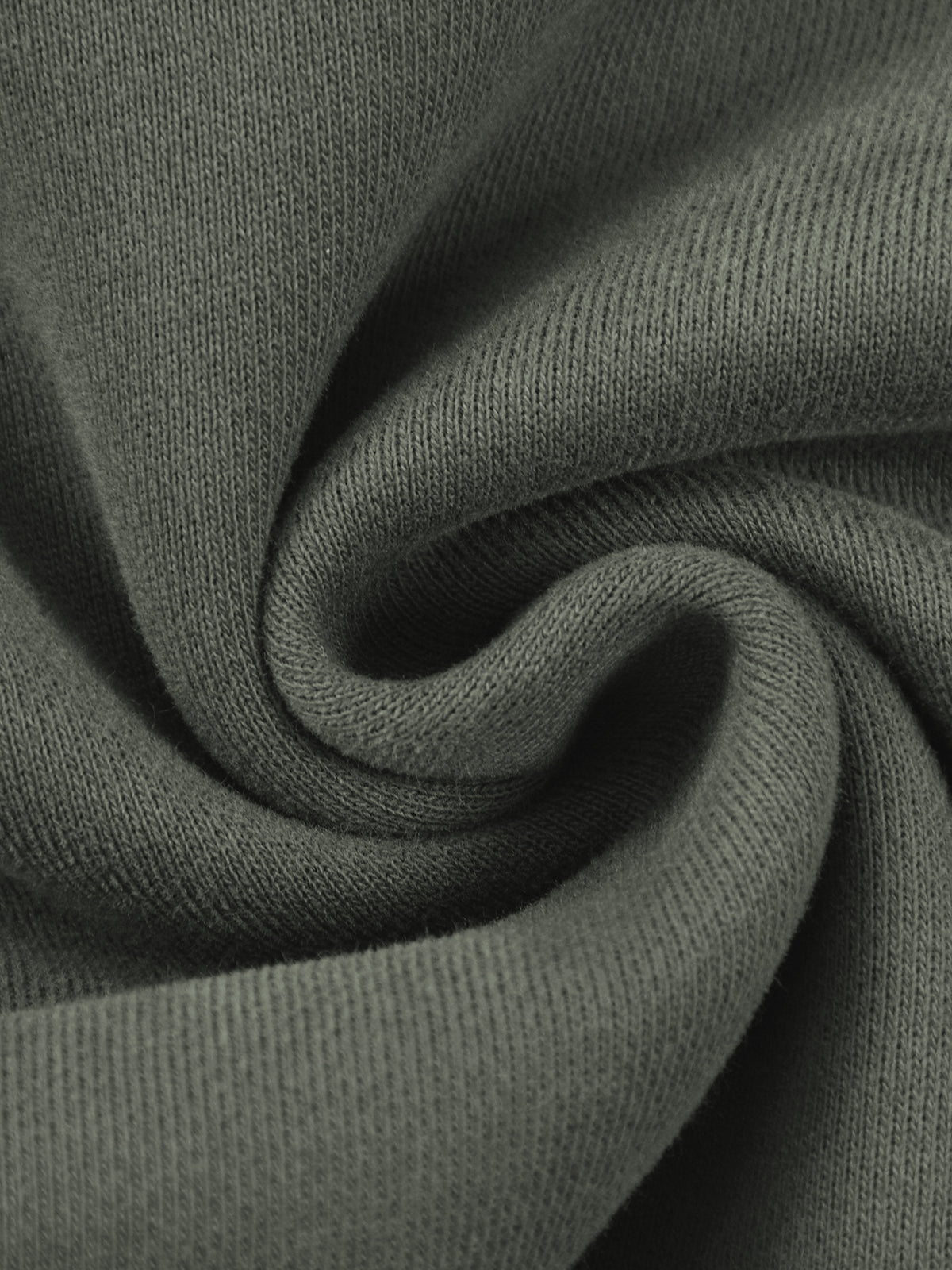A close-up of dark olive green knit fabric with a soft, swirled texture.